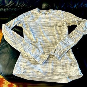 Lululemon stretch fit jersey top with zippered back pocket.